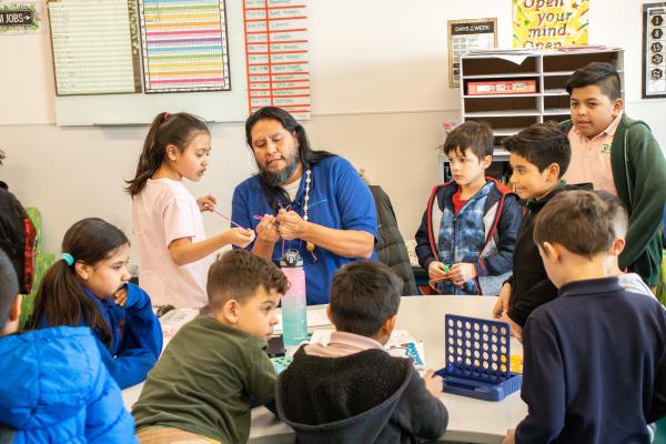 Nate teaching school-age kids at Neighborhood House's afterschool program