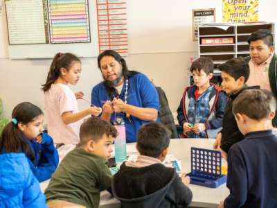 Nate teaching school-age kids at Neighborhood House's afterschool program